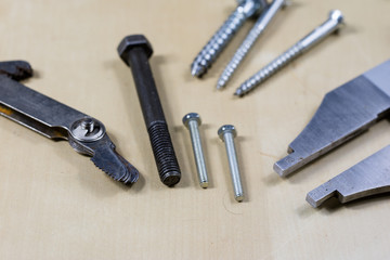 Tools and measuring accessories on a wooden workshop table. Making control measurements using calipers, micrometers and other measuring tools.