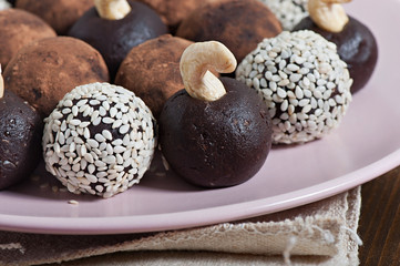 Chocolate sesame candy laid out on a plate, on an old wooden background.
