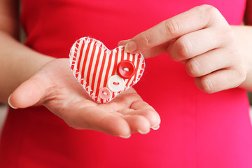 Image of woman holds a beautiful small heart