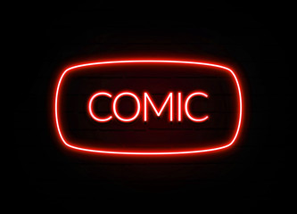 Comic neon sign on brick wall background.