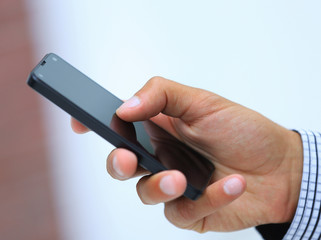 closeup.a man holds a smartphone.