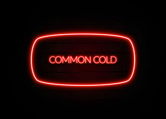 Common Cold neon sign on brick wall background.