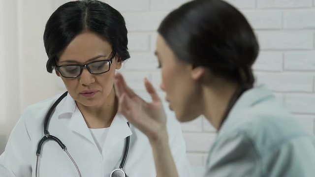 Unhappy woman complaining about disease to gynecologist, incurable illness