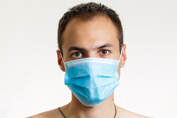 Close up portrait of young doctor in mask isolated on white background