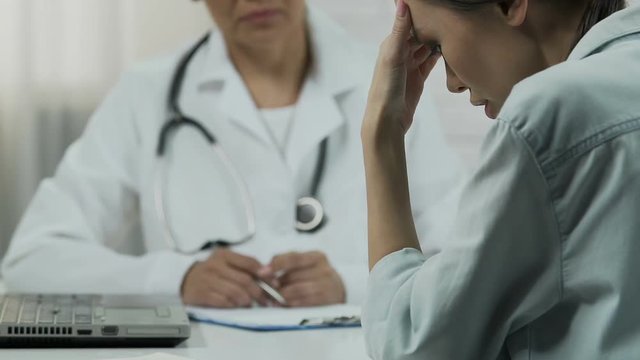 Female patient listening about incurable disease at doctors room, bad news