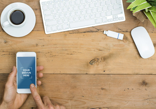 Smarphone User at Wooden Desk with Coffee Mockup 1