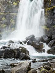 Öxarárfoss falls over rocks along the Öxará River in Þingvellir National Park in Southwest Iceland