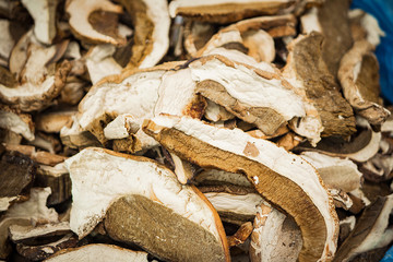 A lot of dried mushrooms on the store shelves, vegetable themes