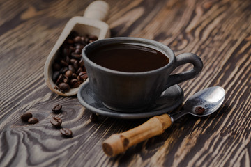 strong black coffee beans,coffee, black roasted arabica coffee beans and cup full of coffee