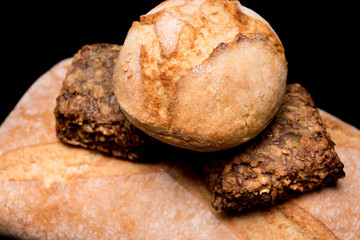 bread roll, bread on a black background, isolated