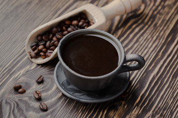 Obraz na płótnie Canvas strong black coffee beans,coffee, black roasted arabica coffee beans and cup full of coffee