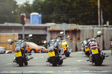 motorcycles stand in the parking lot in anticipation of riders, motorcycle rear view, moto travel