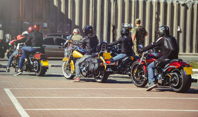 a column of motorcycles ride along the road, a motorcycle view from behind, a motor tour
