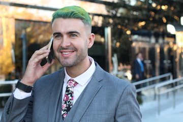 Funky businessman with a very edgy look calling by phone