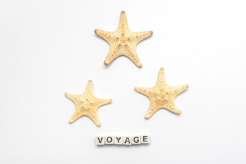 Three starfish on a white background with an inscription voyage