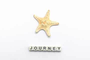 One starfish on a white background with an inscription journey