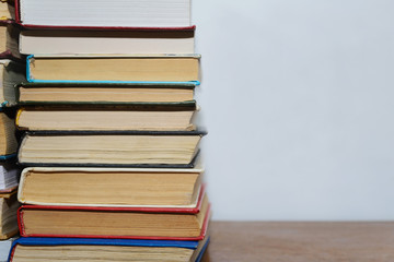 Stack of different books on a woogen table