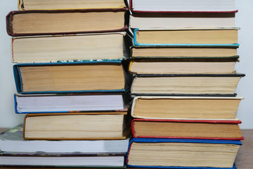 Stack of different books on a woogen table