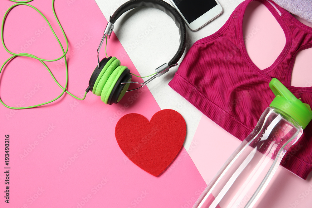 Wall mural gym stuff and red heart on color background. cardio training concept