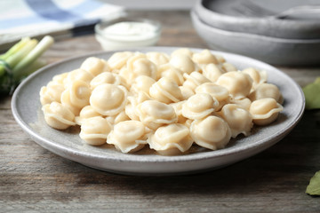 Plate with tasty meat dumplings on table