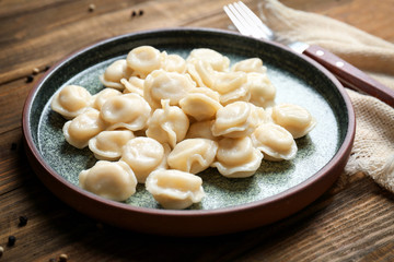 Plate with tasty meat dumplings on table