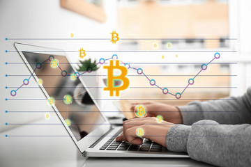 Woman using laptop while holding credit card at table. Internet shopping concept