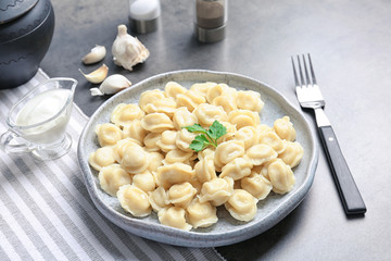 Plate with tasty meat dumplings on table