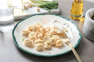 Plate with tasty meat dumplings on table