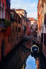 Beautiful Venice sunset cityscape, narrow water canal, bridge and traditional buildings. Italy, Europe.