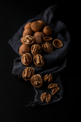 Beautifully presented walnuts on dark slate plate kitchen with napkin table can be used as background