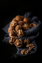 Beautifully presented walnuts on dark slate plate kitchen with napkin table can be used as background