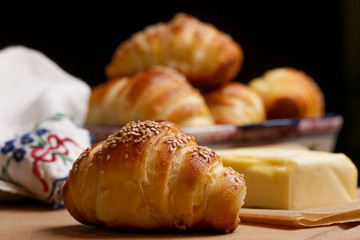Freshly baked croissants and butter on the table