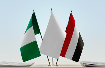 Flags of Nigeria and Yemen with a white flag in the middle