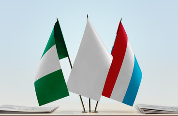 Flags of Nigeria and Luxembourg with a white flag in the middle