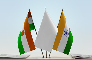 Flags of Niger and India with a white flag in the middle