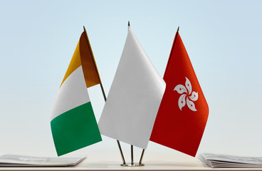 Flags of Ivory Coast and Hong Kong with a white flag in the middle