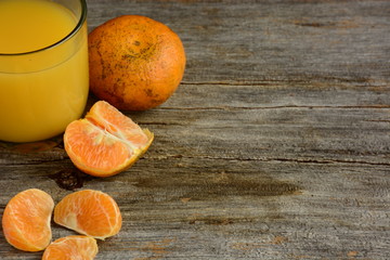 The glass of fresh orange juice with dumbbells 