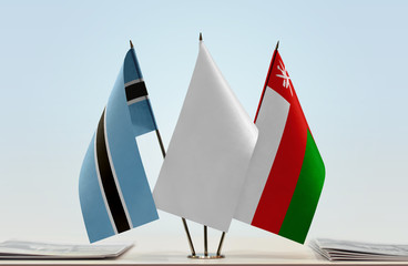 Flags of Botswana and Oman with a white flag in the middle