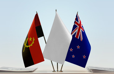 Flags of Angola and New Zealand with a white flag in the middle