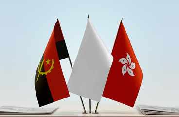 Flags of Angola and Hong Kong with a white flag in the middle