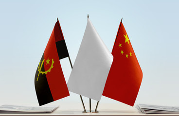 Flags of Angola and China with a white flag in the middle