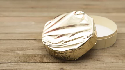 Fototapeten Beautiful Round of Soft Cheese with Gold Foil Wrapper © pamela_d_mcadams