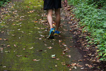 marathon runner running in rocks mountain. closeup of legs compression socks and shoes