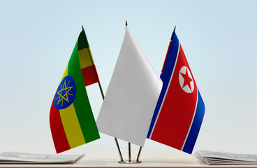 Flags of Ethiopia and North Korea with a white flag in the middle