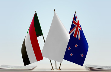 Flags of Sudan and New Zealand with a white flag in the middle