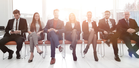 colleagues sitting in the conference room before the meeting