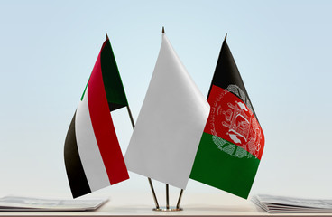 Flags of Sudan and Afghanistan with a white flag in the middle