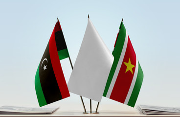 Flags of Libya and Suriname with a white flag in the middle
