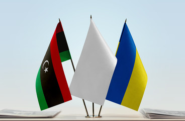 Flags of Libya and Ukraine with a white flag in the middle