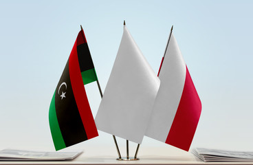 Flags of Libya and Poland with a white flag in the middle
